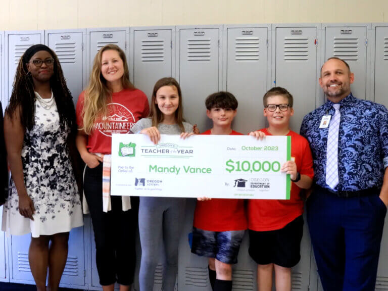 2024 Teacher of the Year Winner Mandy Vance holding a check