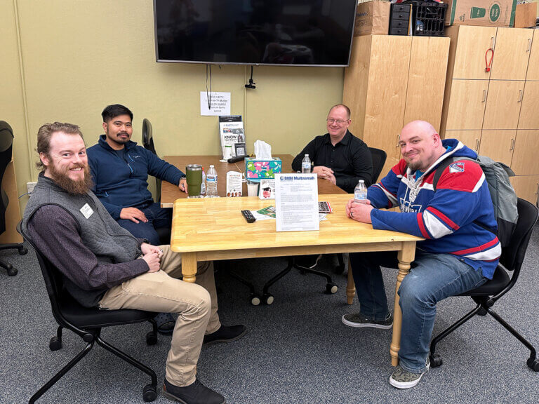 Four men use a student veterans resource center