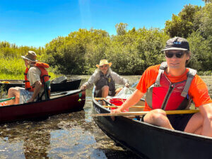 Volunteers in canoes on the Willamette River.